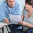 Young woman in wheelchair working with a male colleague - Вечер Елабуги